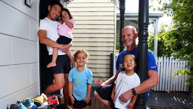 Paul and Joshua with their three children at home